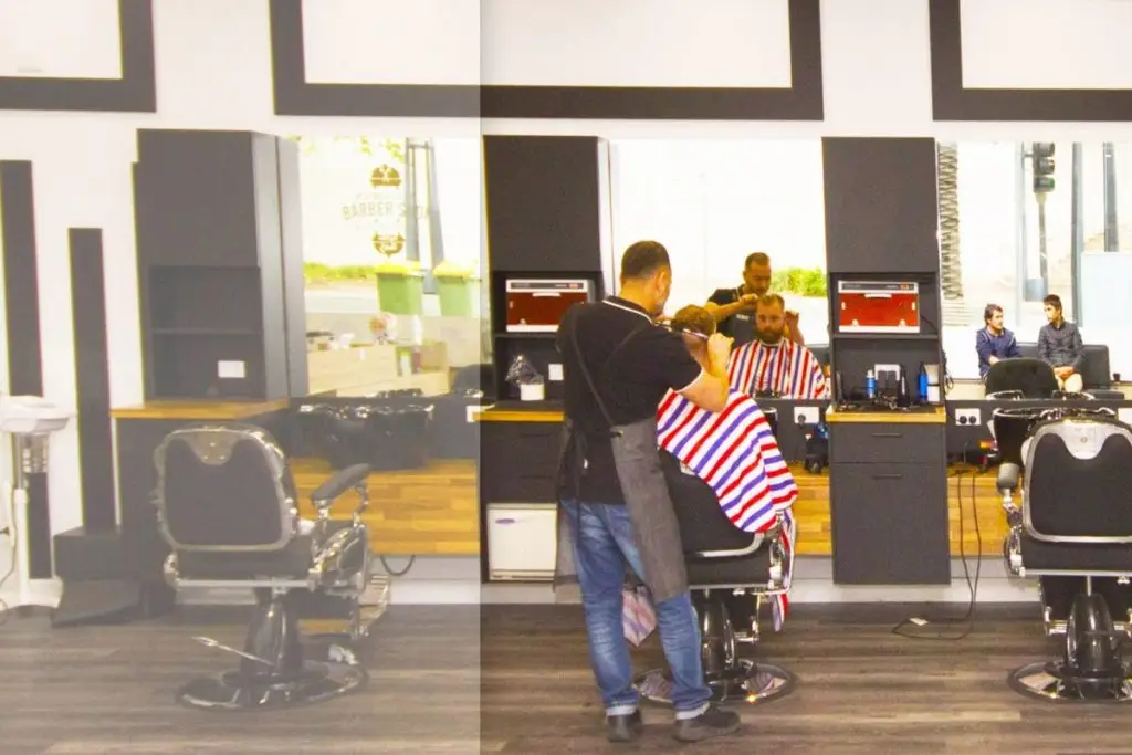 A barber working on a neatly blended men’s fade at Tamadon Barbers in Dandenong.